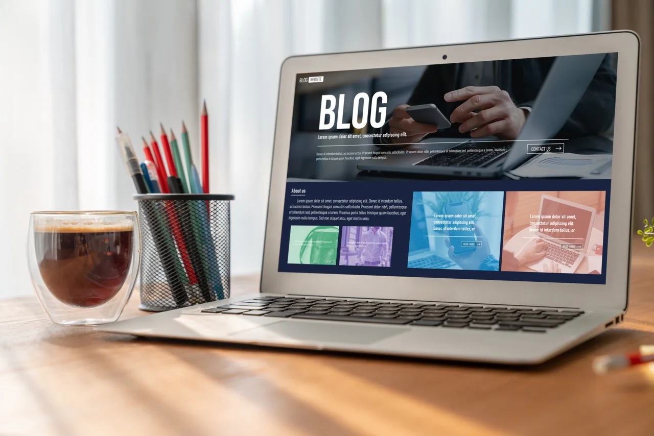 Blog website interface displayed on laptop on office desk